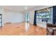 Open living room with hardwood floors, sliding glass doors, and large window at 10684 Downing St, Northglenn, CO 80233