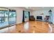 Bright living room with hardwood floors, fireplace, and access to the outdoor deck at 10684 Downing St, Northglenn, CO 80233