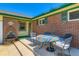 Inviting front patio with outdoor seating and decorative water fountain feature at 10684 Downing St, Northglenn, CO 80233