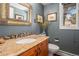 Charming bathroom showcasing a granite vanity, decorative mirror, and unique artistic accents at 2308 Hearth Dr # 37, Evergreen, CO 80439