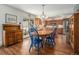 Cozy dining area with bright blue chairs adjacent to a kitchen with wood cabinetry at 2308 Hearth Dr # 37, Evergreen, CO 80439