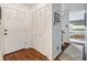 Inviting foyer with wooden floors and ample closet space leading into a cozy, carpeted living area at 2308 Hearth Dr # 37, Evergreen, CO 80439