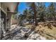 Comfortable covered patio with outdoor seating and views of the surrounding trees and parking at 2308 Hearth Dr # 37, Evergreen, CO 80439