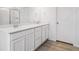 Elegant bathroom with a double sink vanity, quartz countertop, and a large mirror at 45940 Gentry Ave, Bennett, CO 80102