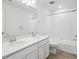 Modern bathroom with double vanity, quartz countertop, tile flooring and shower and tub at 45940 Gentry Ave, Bennett, CO 80102