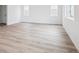Spacious bedroom featuring luxury vinyl plank flooring and natural light at 45940 Gentry Ave, Bennett, CO 80102