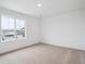 Well-lit bedroom featuring plush carpeting, white walls and a large window with neighborhood views at 45940 Gentry Ave, Bennett, CO 80102
