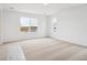 Bright bedroom with neutral carpet, white walls and multiple windows offering neighborhood views at 45940 Gentry Ave, Bennett, CO 80102