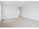 Carpeted bedroom with white walls and an open doorway at 45940 Gentry Ave, Bennett, CO 80102