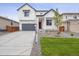 Charming two-story home with a well-manicured lawn and inviting front porch at 45940 Gentry Ave, Bennett, CO 80102
