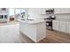 A modern kitchen featuring an island, stainless steel appliances and access to a patio at 45940 Gentry Ave, Bennett, CO 80102