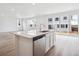 A large kitchen island with stainless steel dishwasher and sliding glass doors to the patio at 45940 Gentry Ave, Bennett, CO 80102