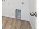 Close-up of the laundry hookups and laminate flooring in the laundry room at 45940 Gentry Ave, Bennett, CO 80102