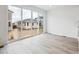 Bright open concept living room with access to patio through large sliding glass doors at 45940 Gentry Ave, Bennett, CO 80102