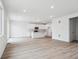 Bright and open living room with new luxury vinyl plank flooring at 45940 Gentry Ave, Bennett, CO 80102