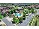 Aerial view of community pool, cabana, and surrounding residences with manicured lawns and sidewalks at 5887 S Taft Ln, Littleton, CO 80127