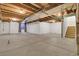 Unfinished basement with exposed ceiling, concrete floor, stairs, and small window at 5887 S Taft Ln, Littleton, CO 80127