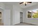 A light and airy bedroom with a sliding closet door and outdoor view at 5887 S Taft Ln, Littleton, CO 80127