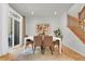 Elegant dining room featuring a modern table, comfortable seating, and natural light at 5887 S Taft Ln, Littleton, CO 80127