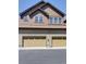 Townhome exterior featuring garages, upper and lower level windows, and a neutral color scheme at 5887 S Taft Ln, Littleton, CO 80127