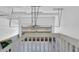 Spacious two car garage with overhead storage and a finished ceiling, viewed from the staircase at 5887 S Taft Ln, Littleton, CO 80127