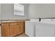 Laundry room with washer, dryer and wooden cabinets with sink at 5887 S Taft Ln, Littleton, CO 80127
