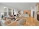 Open-concept living area with hardwood floors, a fireplace, a modern kitchen, and plenty of seating at 5887 S Taft Ln, Littleton, CO 80127