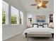Main bedroom featuring multiple bright windows and ceiling fan at 5887 S Taft Ln, Littleton, CO 80127