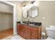 Bathroom vanity featuring double sinks, granite countertop, and a walk-in closet for maximum storage at 3042 N Franklin St, Denver, CO 80205