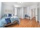 Bright and inviting bedroom featuring blue accents, hardwood floors, and natural light streaming through the windows at 3042 N Franklin St, Denver, CO 80205