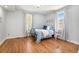 Airy bedroom with blue accents, hardwood floors, and natural light streaming through the windows at 3042 N Franklin St, Denver, CO 80205