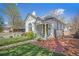 Charming home with covered porch, brick walkway, manicured lawn, and a white picket fence at 3042 N Franklin St, Denver, CO 80205
