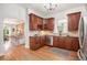 Charming kitchen with wooden cabinets, granite countertops, stainless appliances and seamless access to the dining area at 3042 N Franklin St, Denver, CO 80205