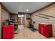 Basement workout area with wood-look flooring, exposed wood walls and red accents at 13438 W 23Rd Pl, Golden, CO 80401