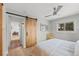 Bedroom featuring hardwood floors, natural light, and a sliding barn door at 13438 W 23Rd Pl, Golden, CO 80401