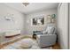 Bedroom with a comfortable chair, soft rug, and natural light, perfect for relaxation at 13438 W 23Rd Pl, Golden, CO 80401