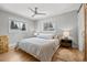 Bedroom with hardwood floors, a ceiling fan, and two windows providing natural light at 13438 W 23Rd Pl, Golden, CO 80401