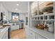 Bright kitchen featuring stainless steel appliances, white cabinets, and quartz countertops at 13438 W 23Rd Pl, Golden, CO 80401