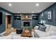 Cozy living room with a stone fireplace, hardwood floors, and built-in bookshelves at 13438 W 23Rd Pl, Golden, CO 80401