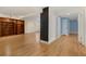 Finished basement with hardwood floors features a built-in bookshelf and access to a blue bedroom at 2552 E Alameda Ave # 104, Denver, CO 80209