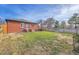 Spacious fenced backyard with a mix of grass and partial view of the house at 3200 Locust St, Denver, CO 80207