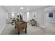 Finished basement rec room with foosball table, bar and seating area, and open stairway to the upper level at 3200 Locust St, Denver, CO 80207