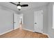 This bedroom features a ceiling fan, wood floors, and an open doorway, making it very appealing at 3200 Locust St, Denver, CO 80207