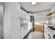 Bright, renovated kitchen with stainless steel appliances, stone countertops, and white cabinetry at 3200 Locust St, Denver, CO 80207