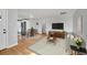Bright living room with hardwood floors, neutral tones, and an open layout to the kitchen at 3200 Locust St, Denver, CO 80207