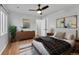 Comfortable main bedroom featuring stylish decor, hardwood floors, neutral paint and ample natural light at 3200 Locust St, Denver, CO 80207
