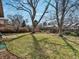 Wide-open backyard with mature trees, a well-maintained lawn, and a wood fence at 2433 S Oneida St, Denver, CO 80224