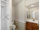 Well-lit bathroom featuring a shower and vanity with storage at 2433 S Oneida St, Denver, CO 80224