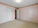 Bedroom showcasing patterned wallpaper, neutral carpet, and closet doors at 2433 S Oneida St, Denver, CO 80224
