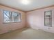 Cozy bedroom featuring patterned wallpaper, neutral carpet, and ample sunlight at 2433 S Oneida St, Denver, CO 80224